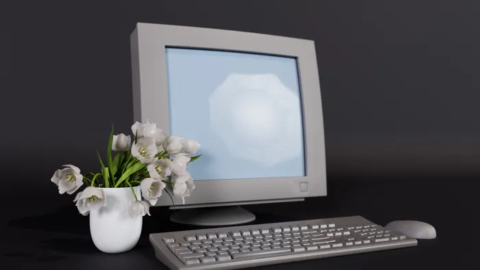 Computadora antigua con monitor de tubo y teclado beige sobre fondo oscuro, junto a un jarrón con tulipanes
